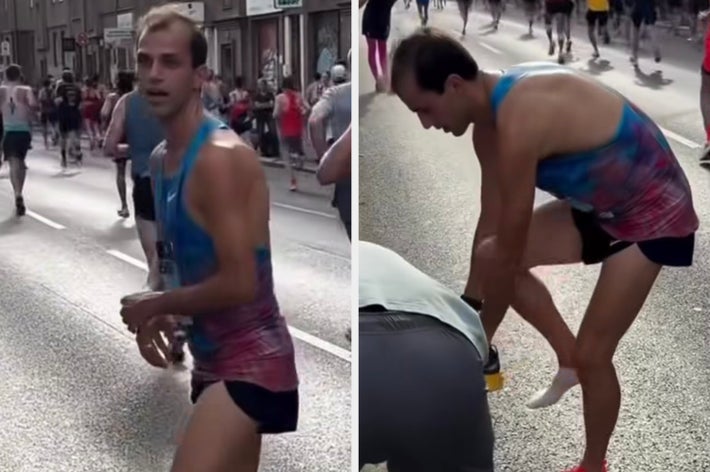 マラソン中のランナーがカメラを振り返りながら走る様子。スポーツウェアとランニングシューズを着用。