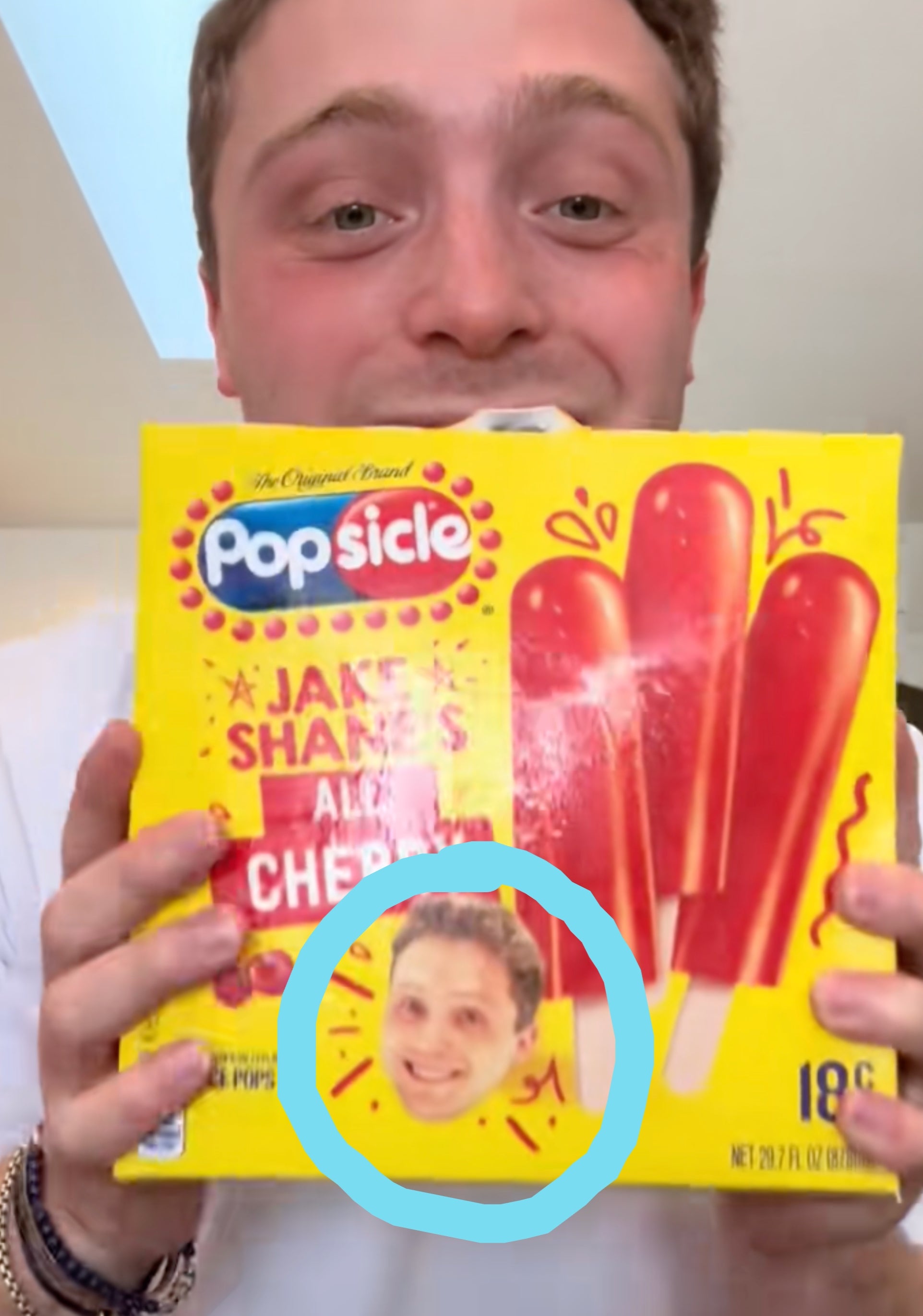 Person holding a box of cherry popsicles, smiling, with "POPSICLE REVEAL #PopsiclePartner" text overlay