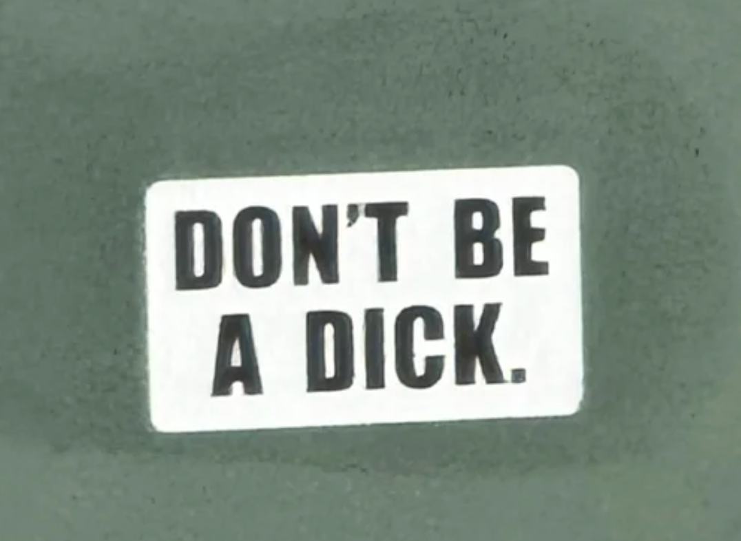 Sign with bold substance   reads, "DON'T BE A DICK."