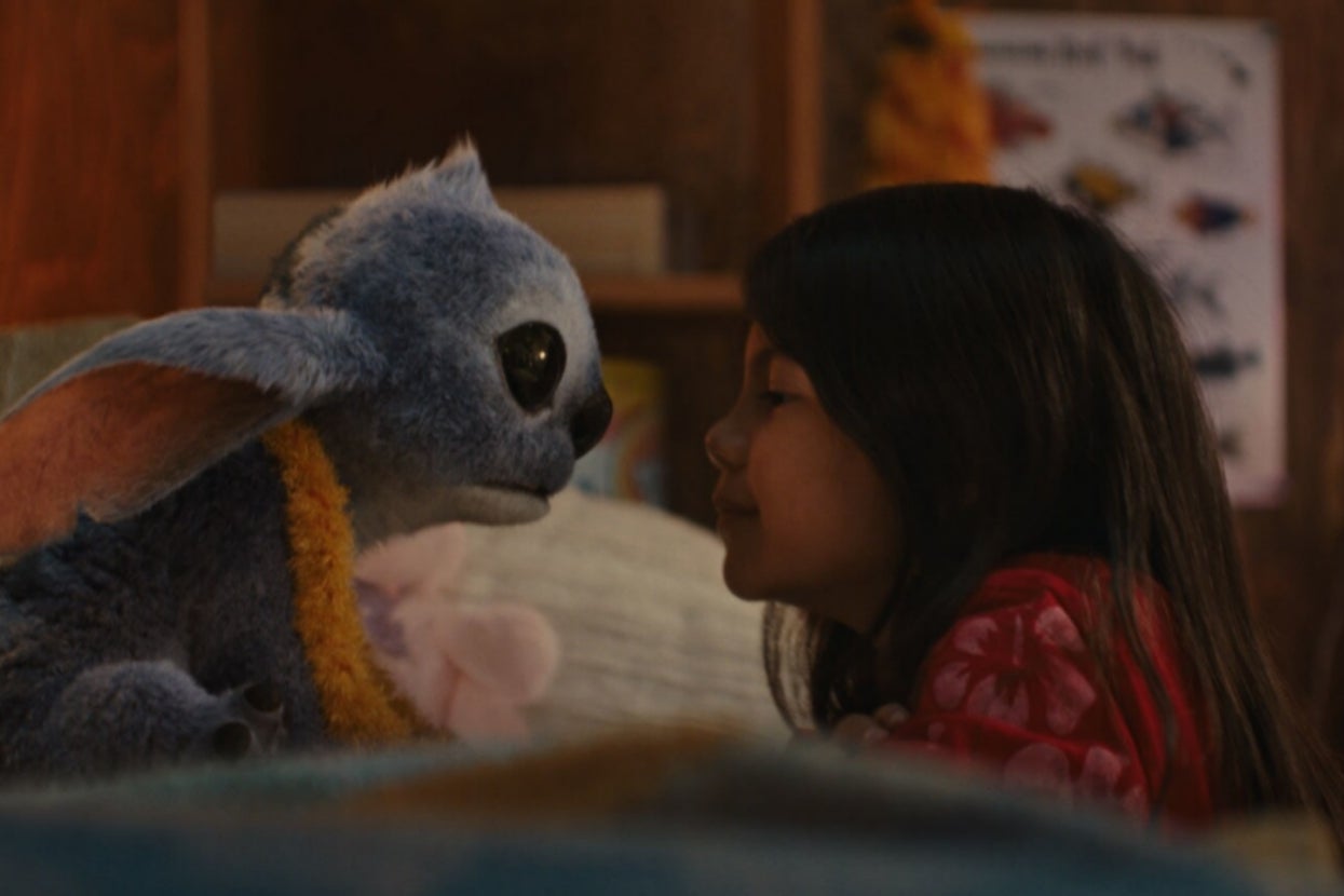 Live-action Lilo and Stitch sitting close to each other