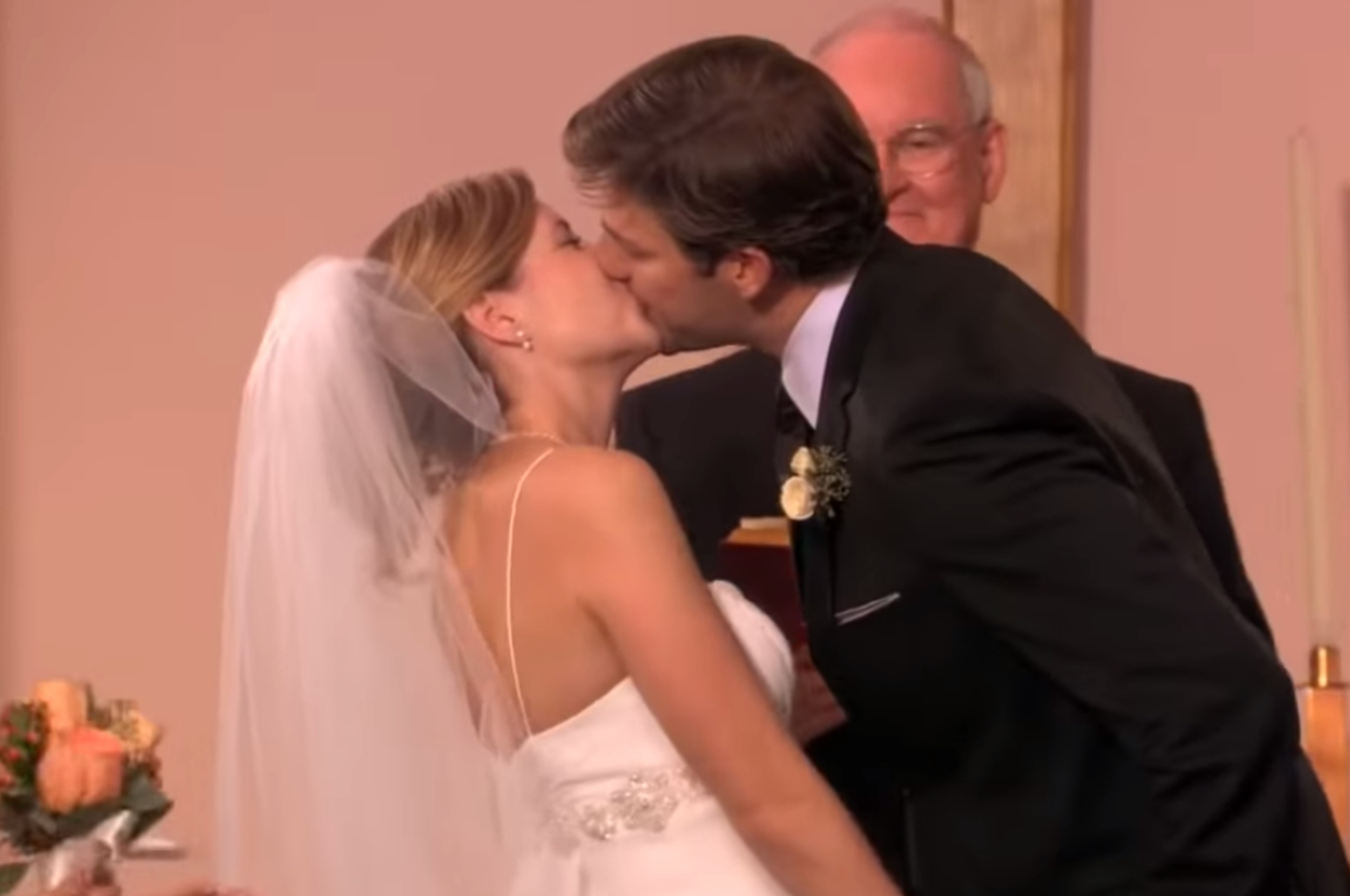 Jim and Pam from The Office kissing at the wedding altar