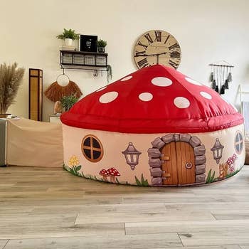 Mushroom-shaped playhouse with whimsical doorway and windows, acceptable successful a cozy country with modern decor elements similar a timepiece and plants. Ideal for kids