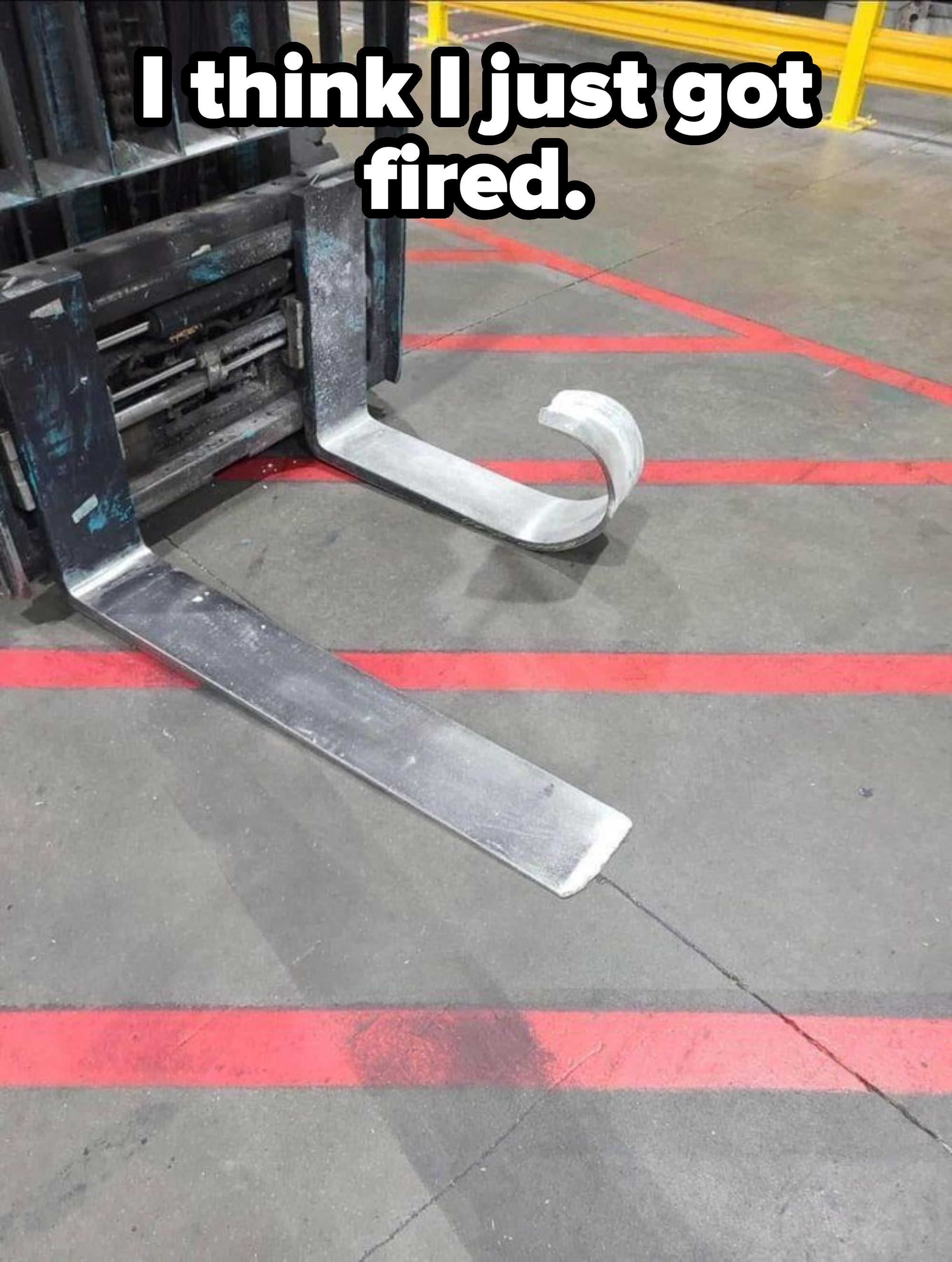 Forklift with a bent fork on a warehouse floor, suggesting damage or malfunction