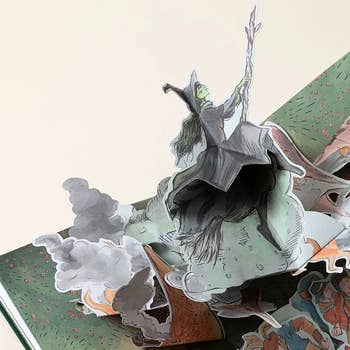 Pop-up publication featuring a witch connected a broomstick, capturing a whimsical country of magic and fantasy