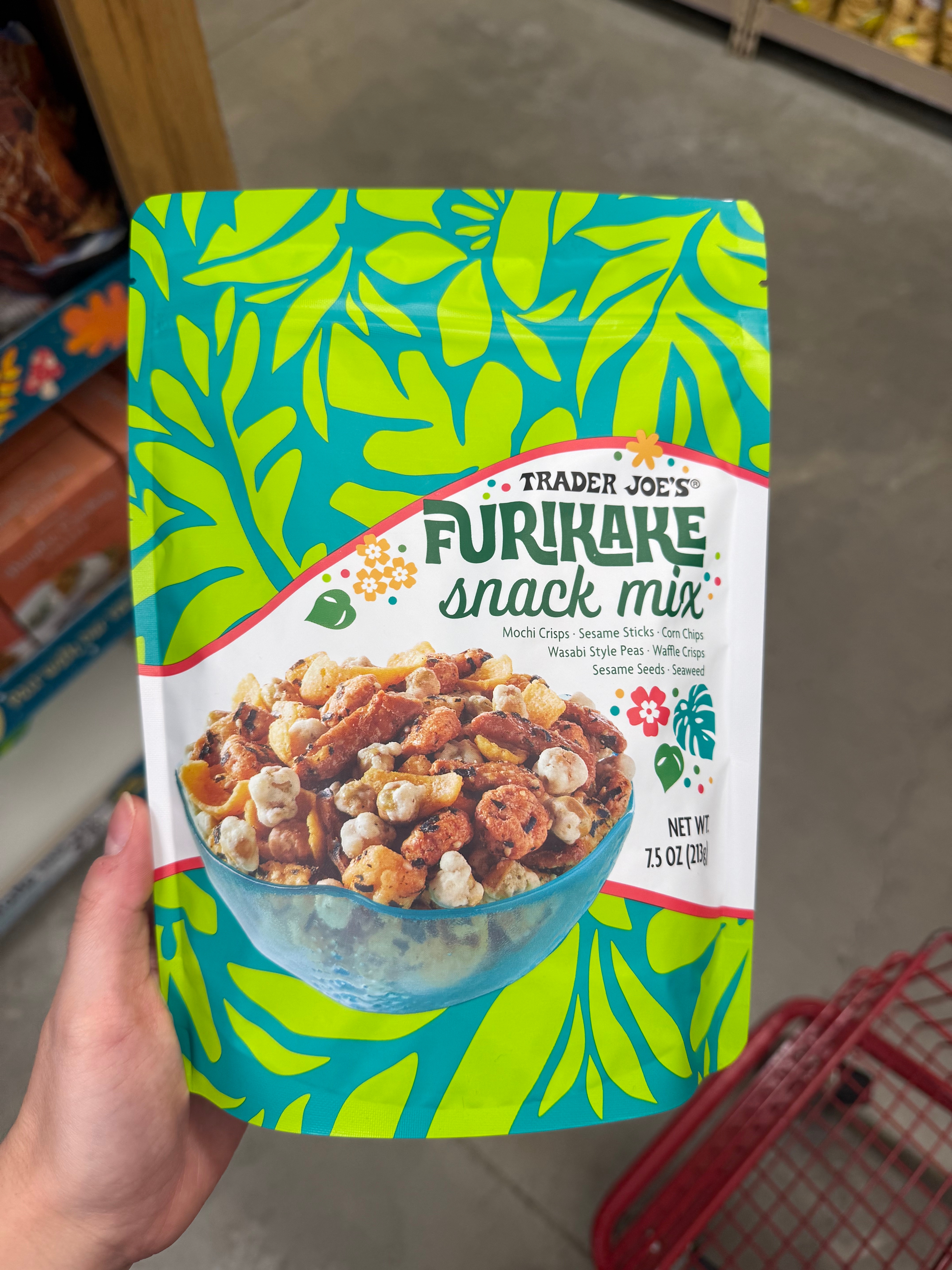 Bag of Trader Joe's Furikake Snack Mix featuring mochi crisps, sesame sticks, peanuts, and more. Bright and tropical package design