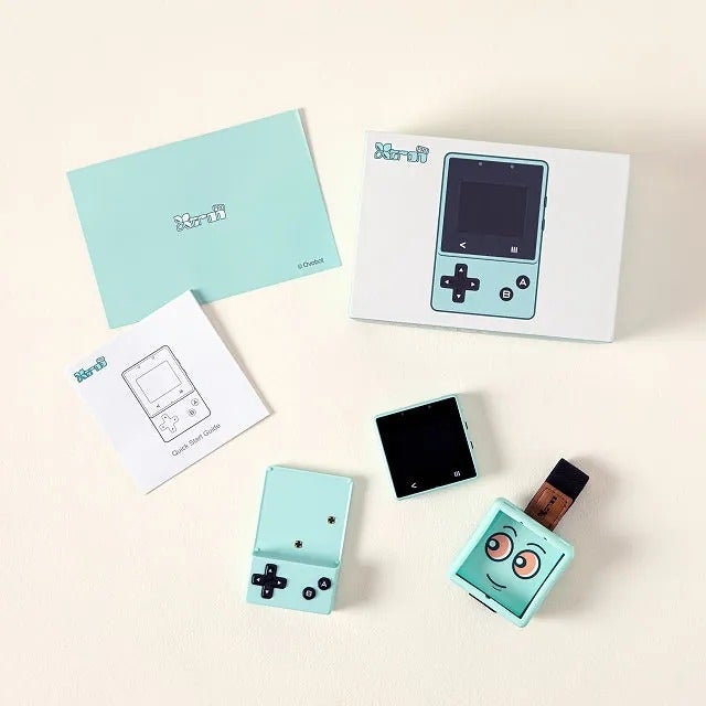 Portable handheld gaming instrumentality  with cartoon face, shown with box, instructions, and detachable screen. Featured successful  a buying  article