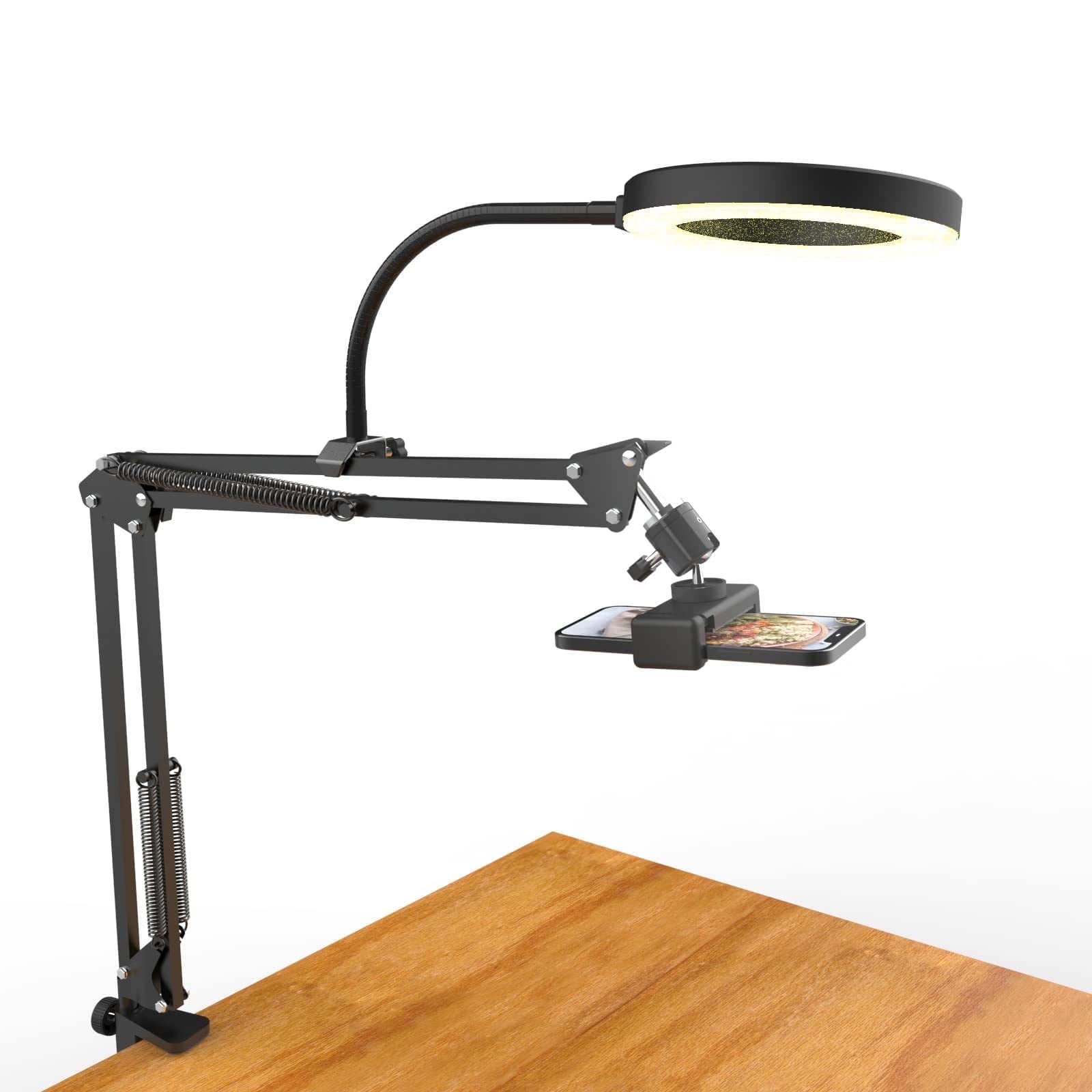 Adjustable phone holder with a built-in ring light, clipped to the edge of a wooden table, designed for hands-free use