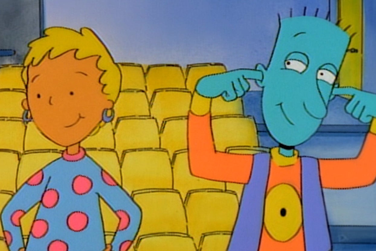 Animated characters in a theater, one with a blue face playfully plugging ears, and the other smiling in a polka dot shirt