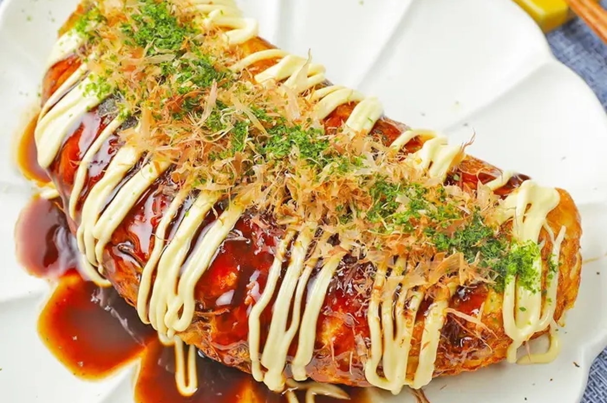 皿に盛られたキャベツと卵のお好み焼き。ソースとマヨネーズがかかり、青のりとかつお節がトッピングされています。