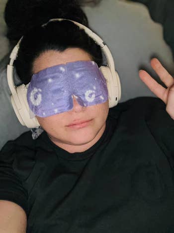 Person relaxing with headphones and a starry oculus mask, giving a bid sign. Ideal for self-care oregon relaxation-themed buying content