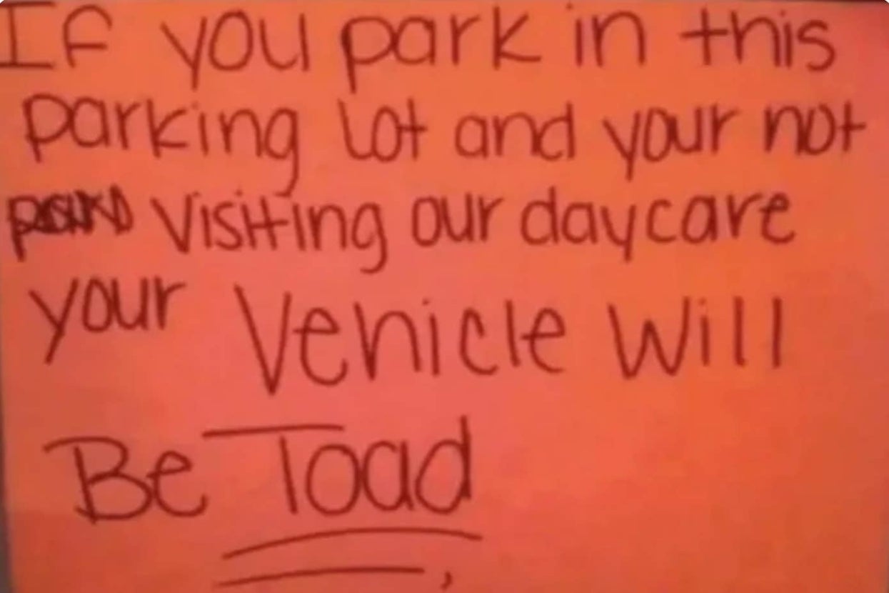 Sign warning unauthorized parking in daycare lot will result in towing