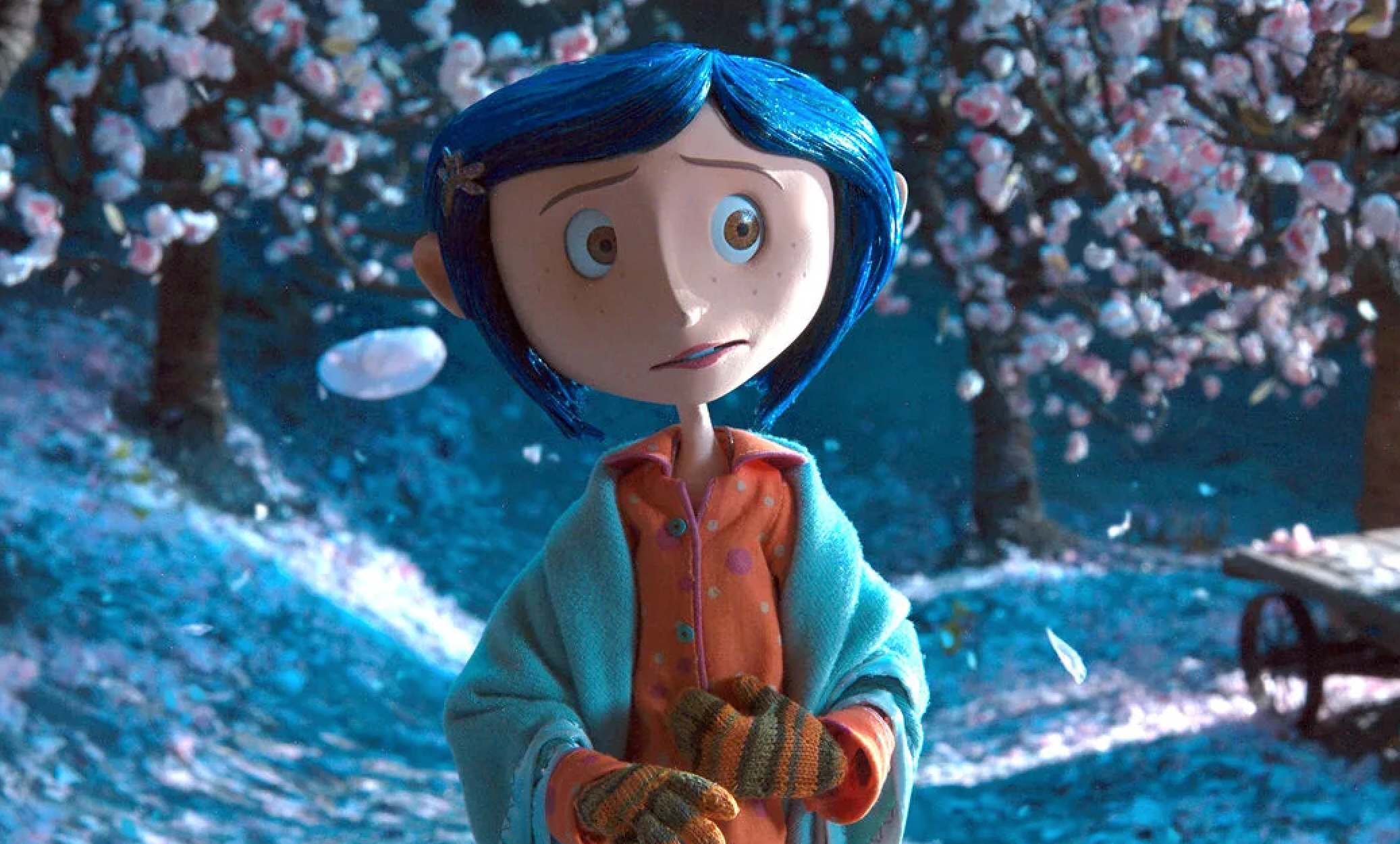 Animated character with blue hair, wearing an orange shirt, a blue jacket, and striped gloves, stands in a snowy forest with blossom trees