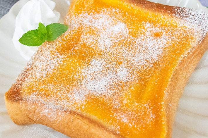 皿にのったかぼちゃプリンが入ったトースト、ホイップクリームとミントが添えてある。