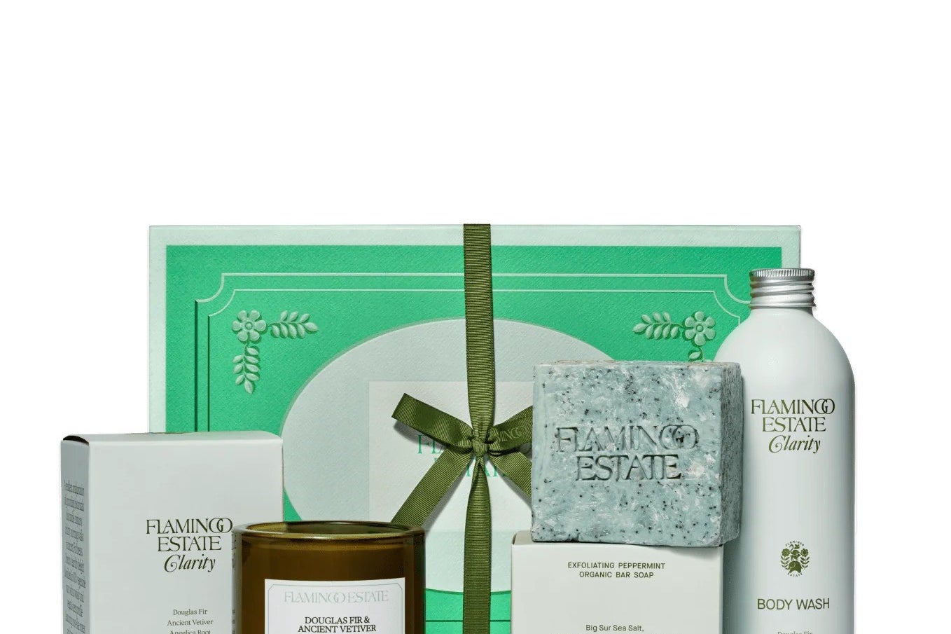 Gift set with a scented candle, body wash, exfoliating soap, and packaging from Flamingo Estate. Featured in a shopping article