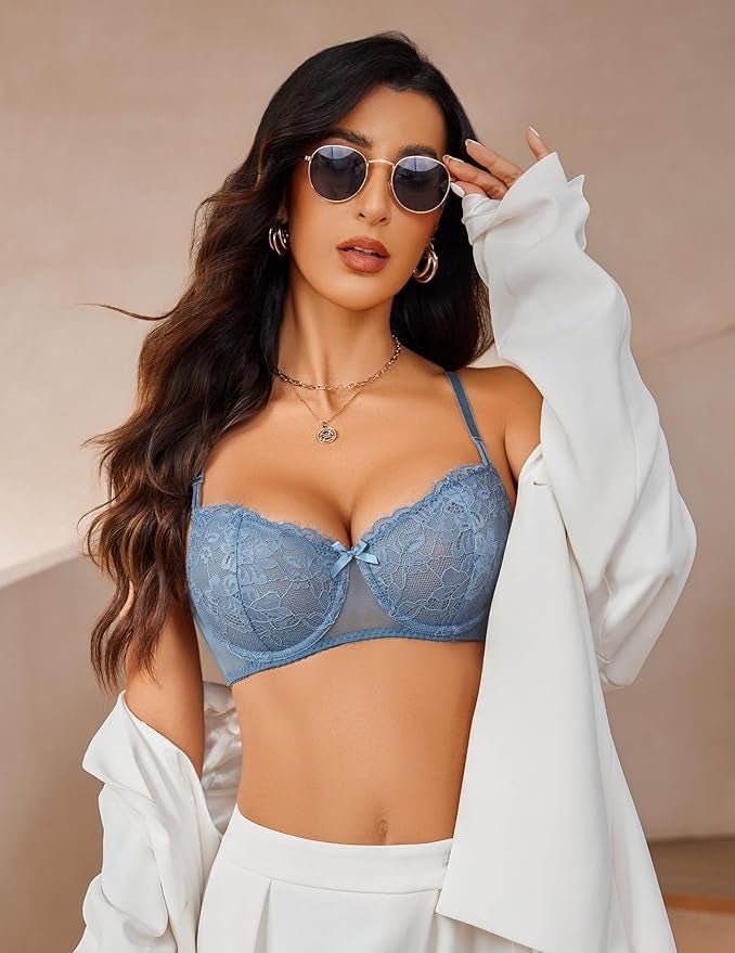 Person wearing sunglasses, bluish  lace lingerie, and a achromatic  jacket, posing with a assured  look  and long, styled hair