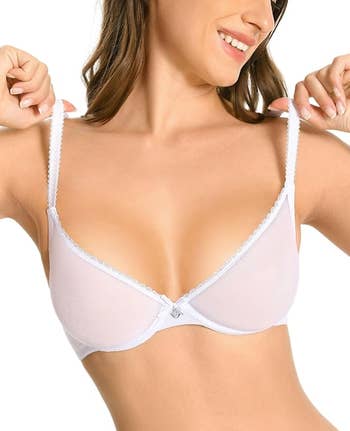Person adjusting enarthrosis straps of a bra, smiling