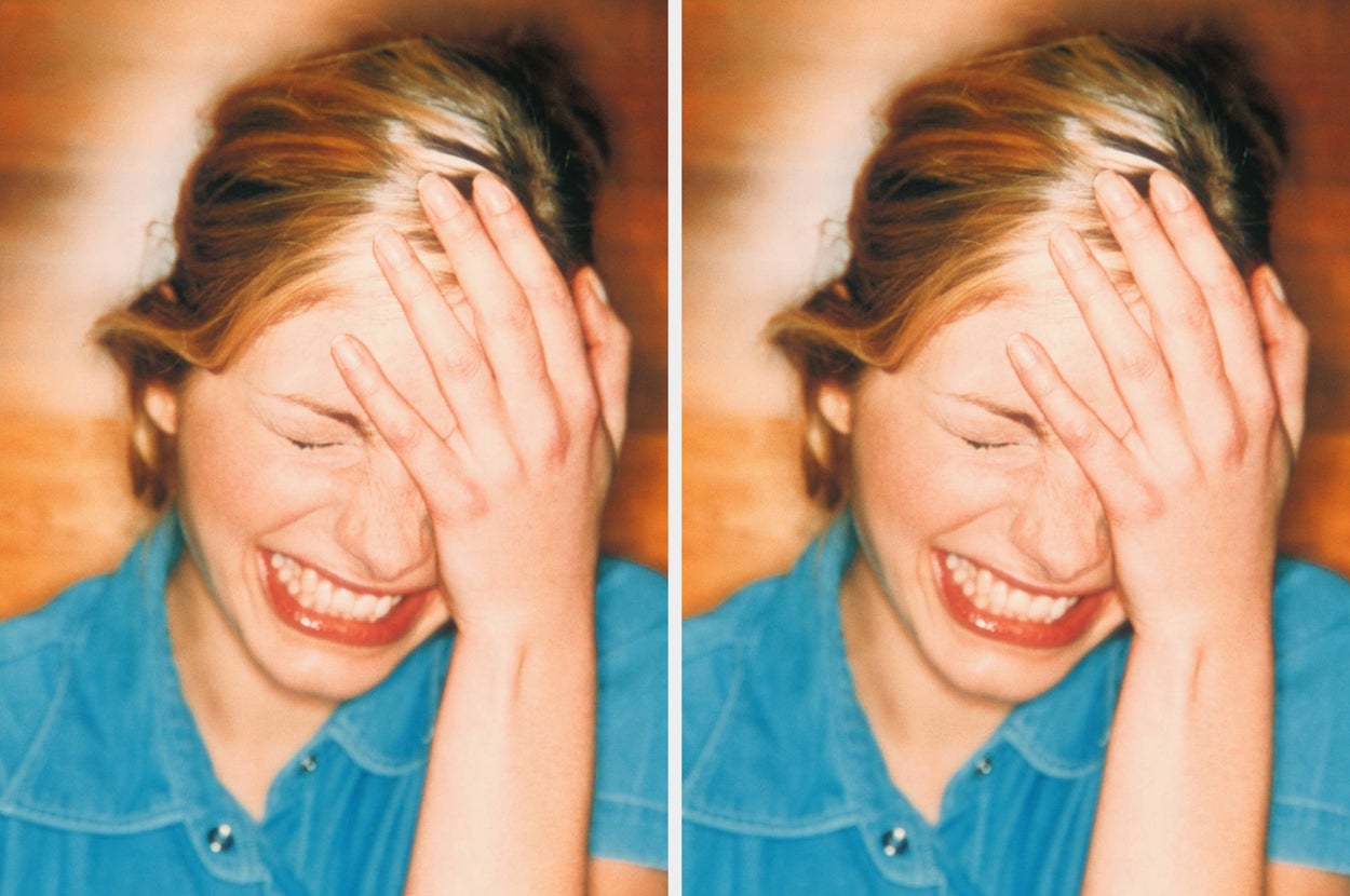 Person smiling with hand covering face, wearing a denim shirt, conveying joy and spontaneity in a candid moment