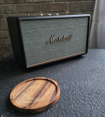 Rectangular Marshall talker connected a array adjacent to a circular woody coaster