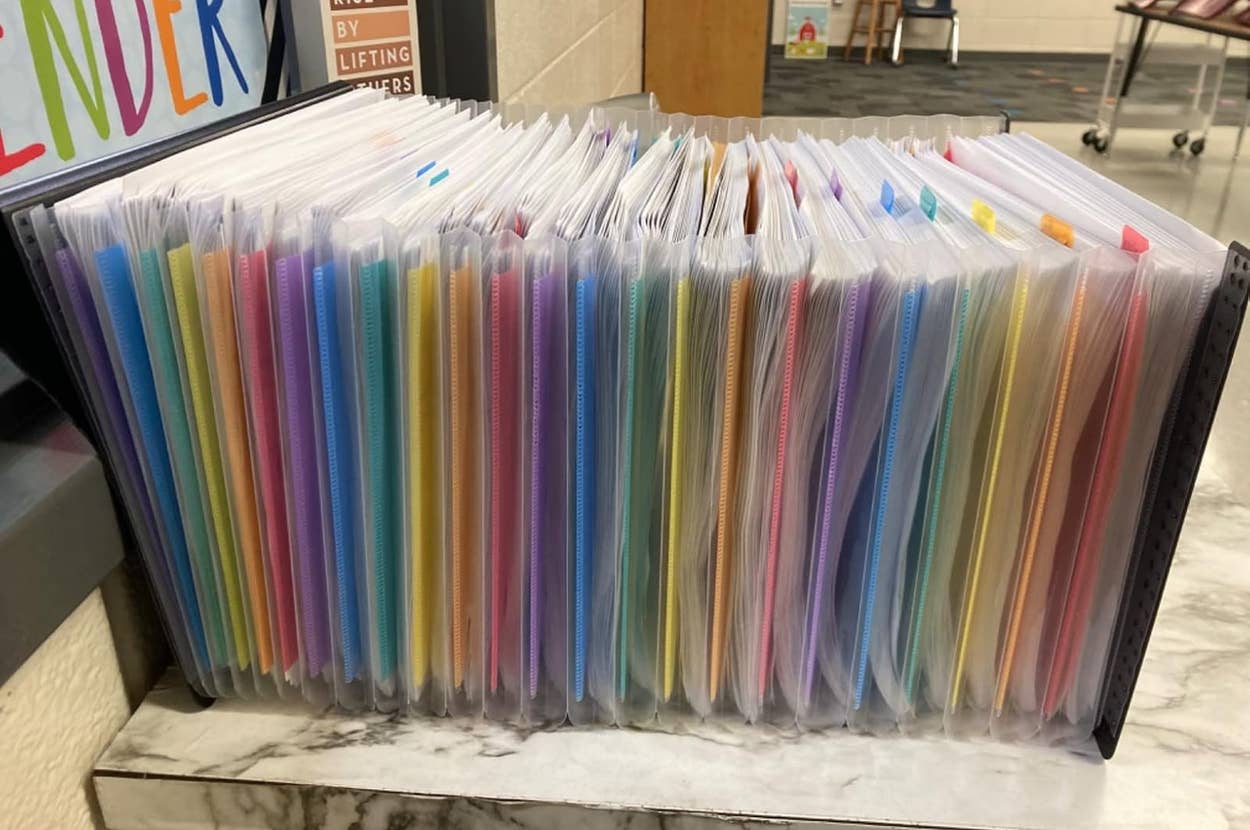 Organized expandable file organizer on a desk with colorful tabbed sections for storing documents