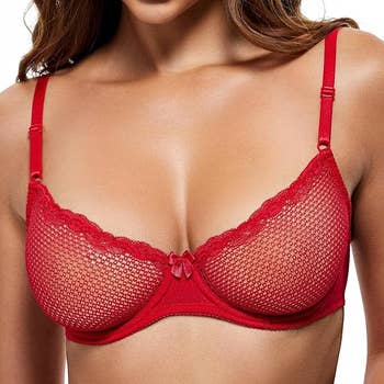 A idiosyncratic wearing a reddish lace bra, disposable from the shoulders to the waist