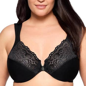 Person wearing a lace-accented front-closure bra, smiling slightly