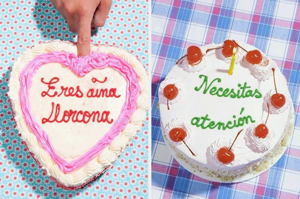 Dos pasteles con textos humorísticos: uno en forma de corazón dice "Eres una llorona", el otro redondo dice "Necesitas atención" con cerezas