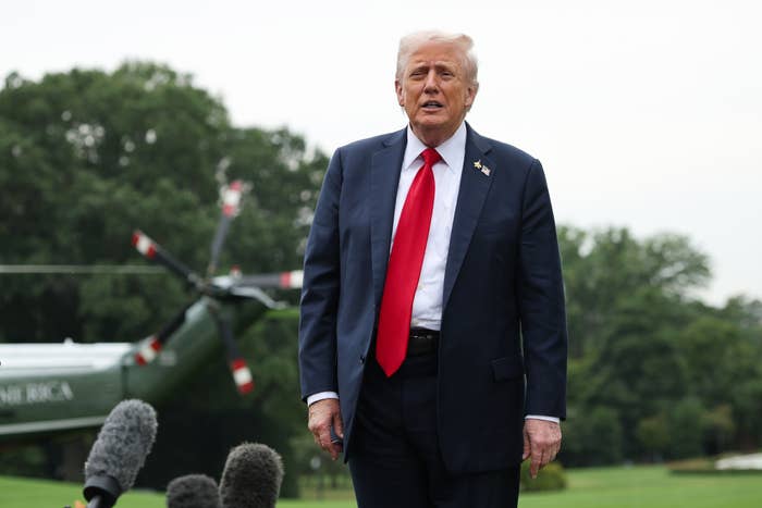 "I've Never Met You": Karoline Leavitt Was Truly Shocked By This Bold Question From The Latinos For Trump Founder 4 A person in a suit and tie speaks outdoors near a helicopter, surrounded by microphones