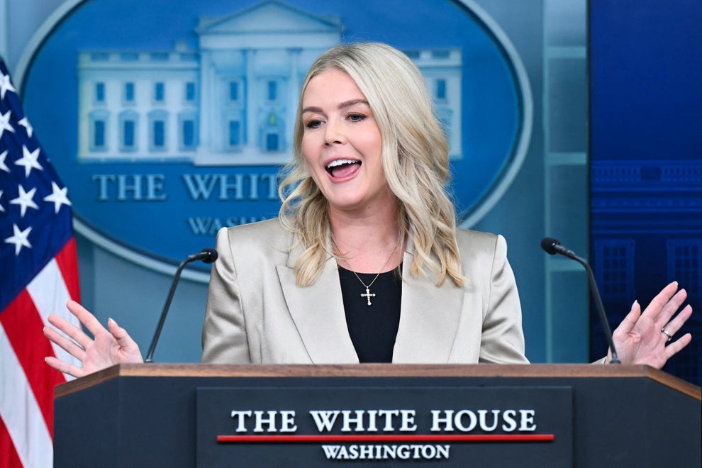 "I've Never Met You": Karoline Leavitt Was Truly Shocked By This Bold Question From The Latinos For Trump Founder 19 A person speaks at a podium in the White House press room, wearing a light blazer over a black top with a cross necklace