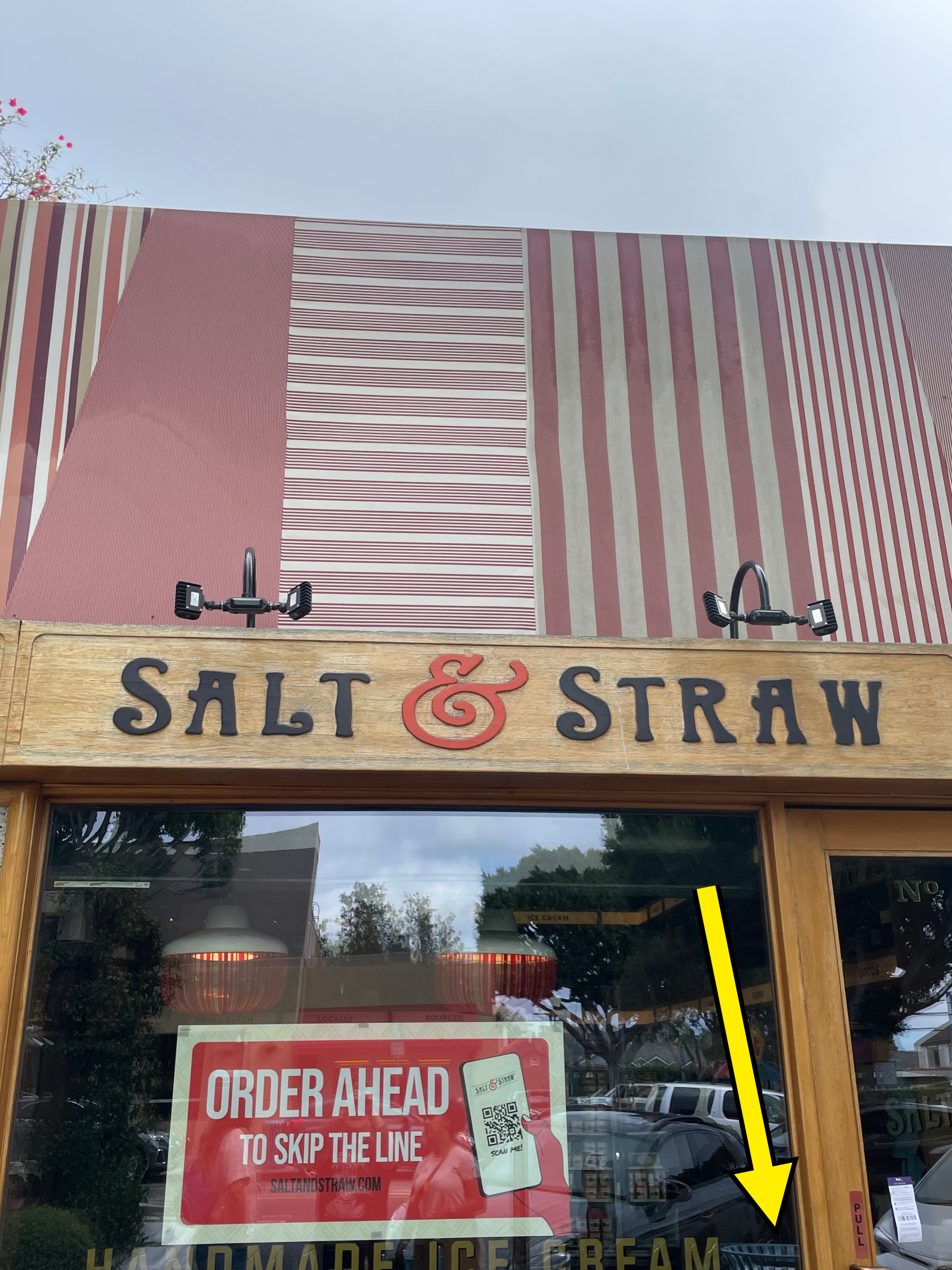 Storefront of Salt & Straw ice cream shop with a sign suggesting customers order ahead to skip the line