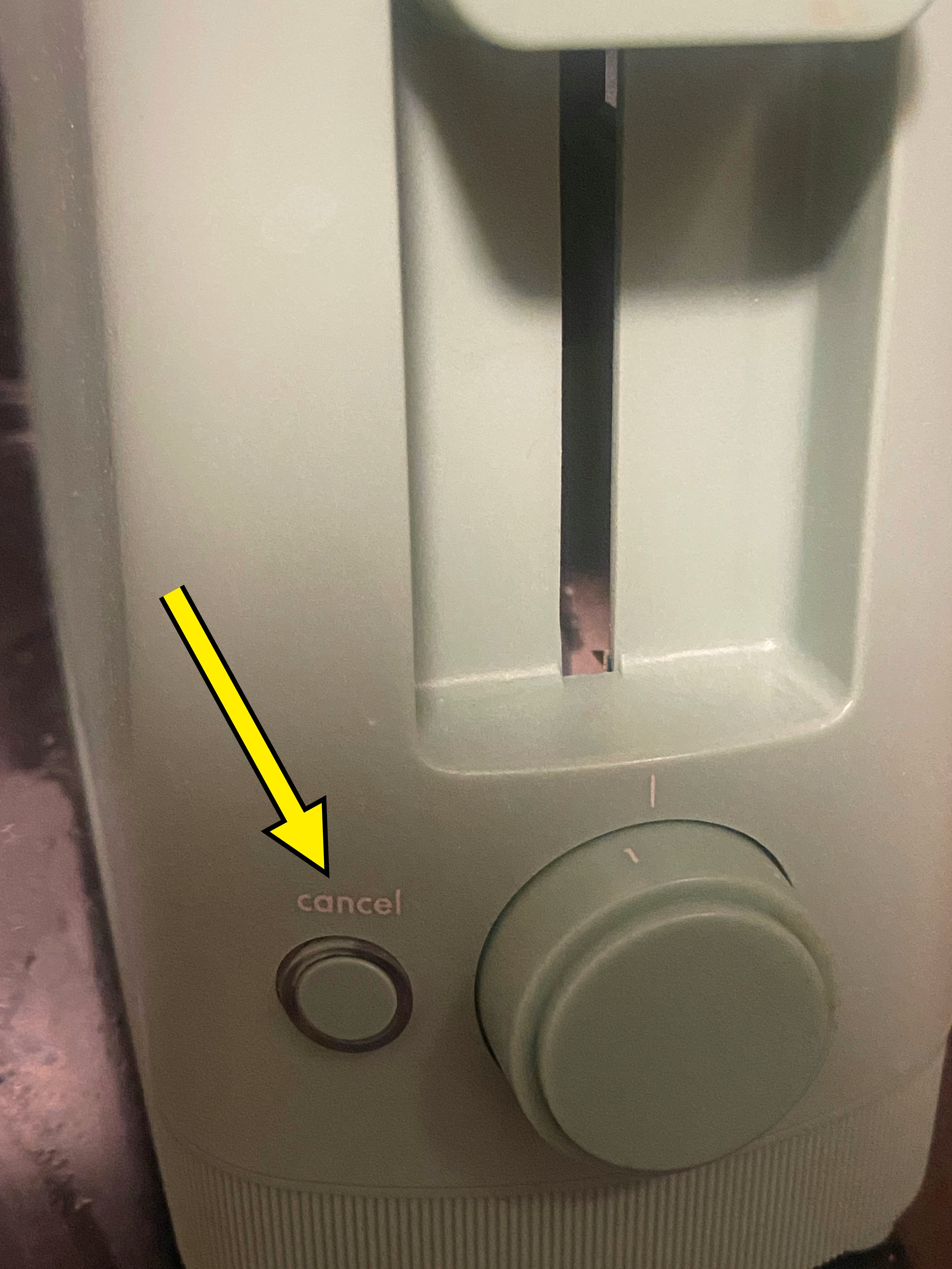 A toaster with a single slot and dial for adjusting settings is shown