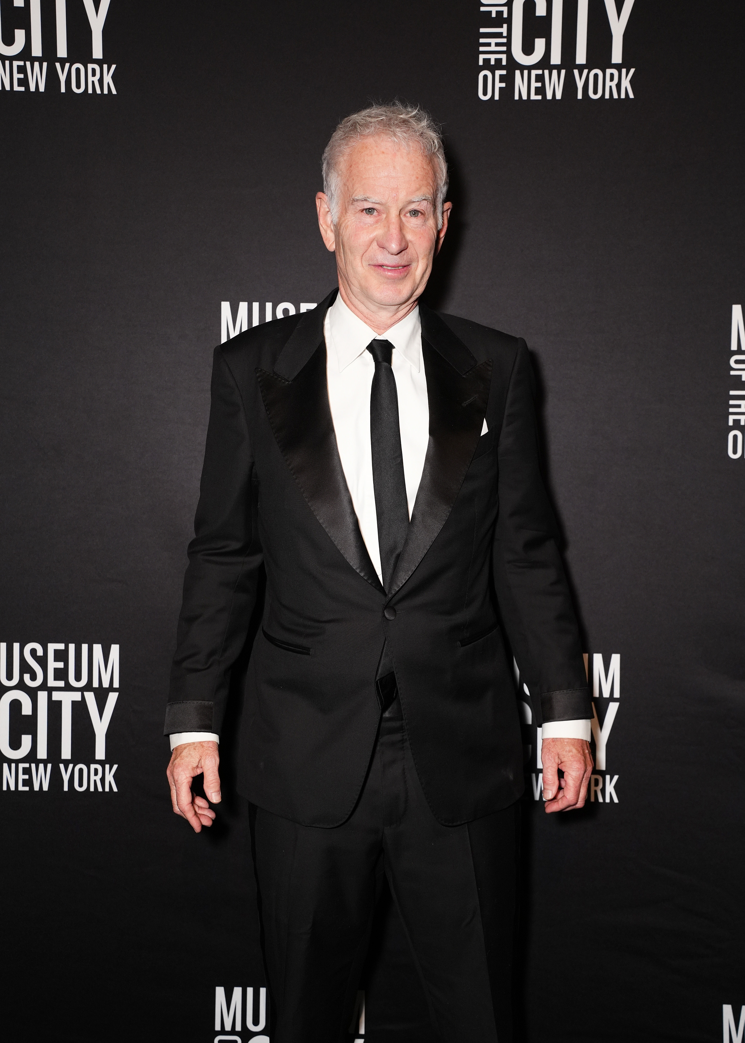 A antheral   successful  a classical  tuxedo poses connected  a reddish  carpet astatine  the Museum of the City of New York event