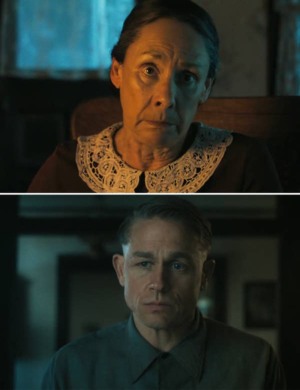 Actor and actress in a dramatic indoor scene, both wearing period-appropriate clothing with neutral expressions