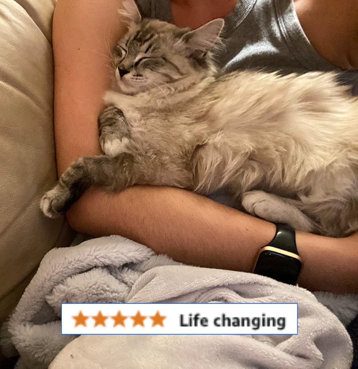 reviewer cuddling their cat with a 5 star review saying 