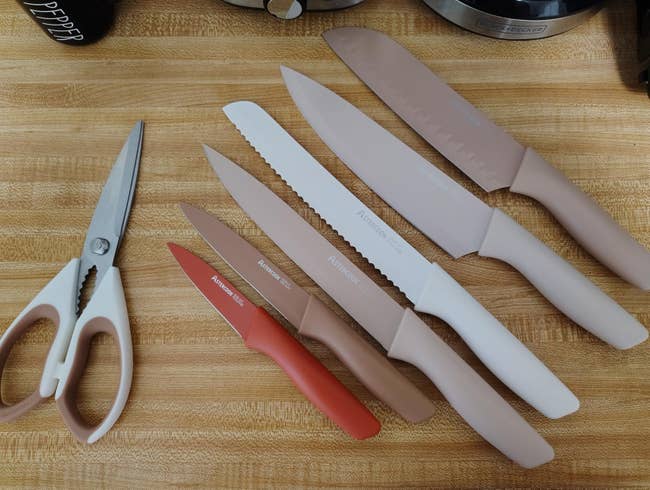 A acceptable of room knives and scissors with non-slip handles displayed connected a countertop