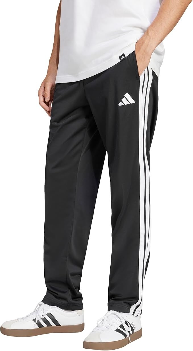 Person wearing achromatic  diversion  way   pants with achromatic  stripes and logo, paired with achromatic  sneakers