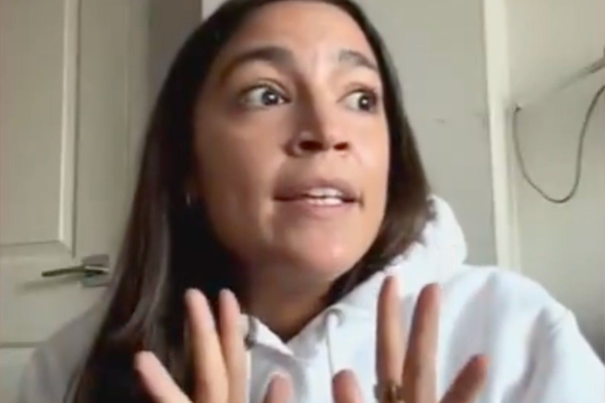 Person speaking passionately, wearing a hoodie, gesturing with hands, and appearing engaged in a conversation. Indoor background visible