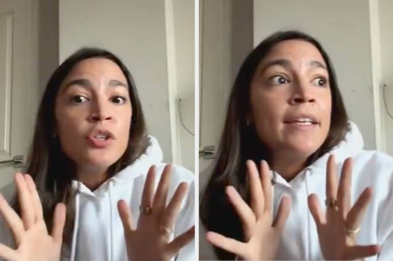 Person gesturing expressively with both hands during a conversation or interview, wearing a casual hoodie