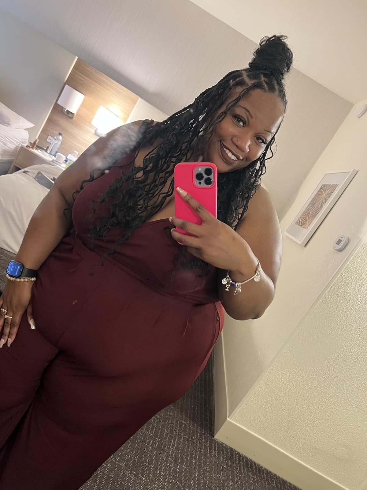 Person successful  a stylish jumpsuit takes a reflector  selfie