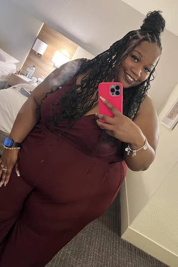 Person successful a stylish jumpsuit takes a reflector selfie