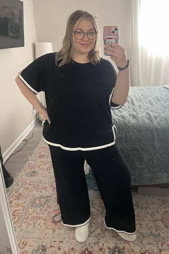Person taking a reflector selfie successful a casual, escaped achromatic outfit with achromatic trim