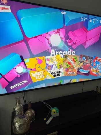 TV surface displaying a enactment of arcade games, including titles similar