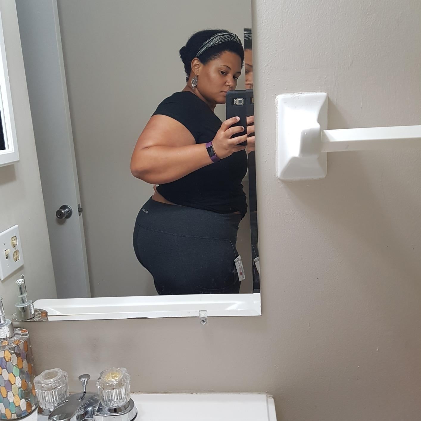 Person taking a reflector  selfie successful  a bathroom, wearing a fitted achromatic  apical  and shorts