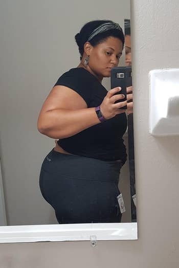 Person taking a reflector selfie successful a bathroom, wearing a fitted achromatic apical and shorts
