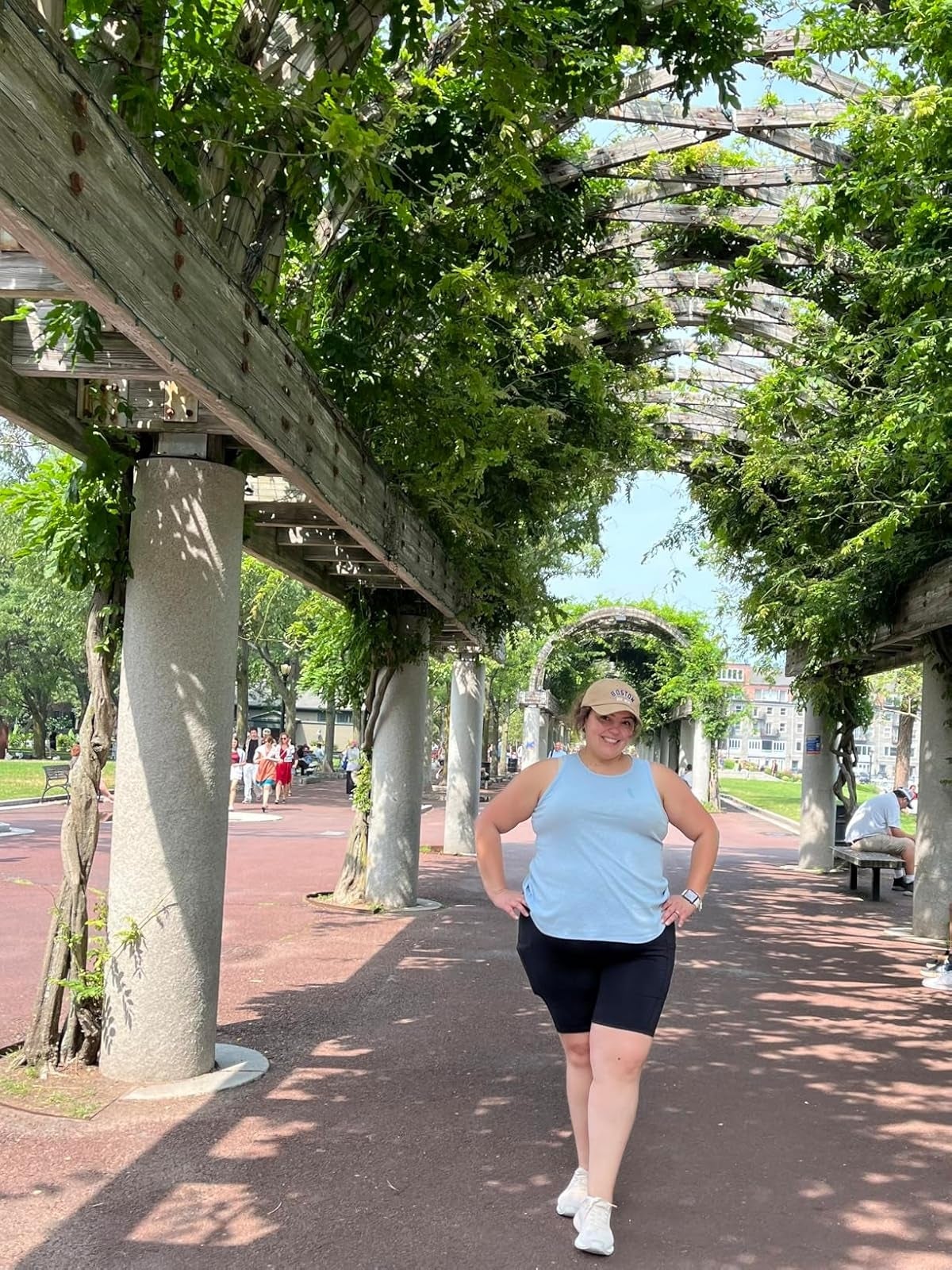 Person successful  a sleeveless top, capri shorts, and sneakers poses