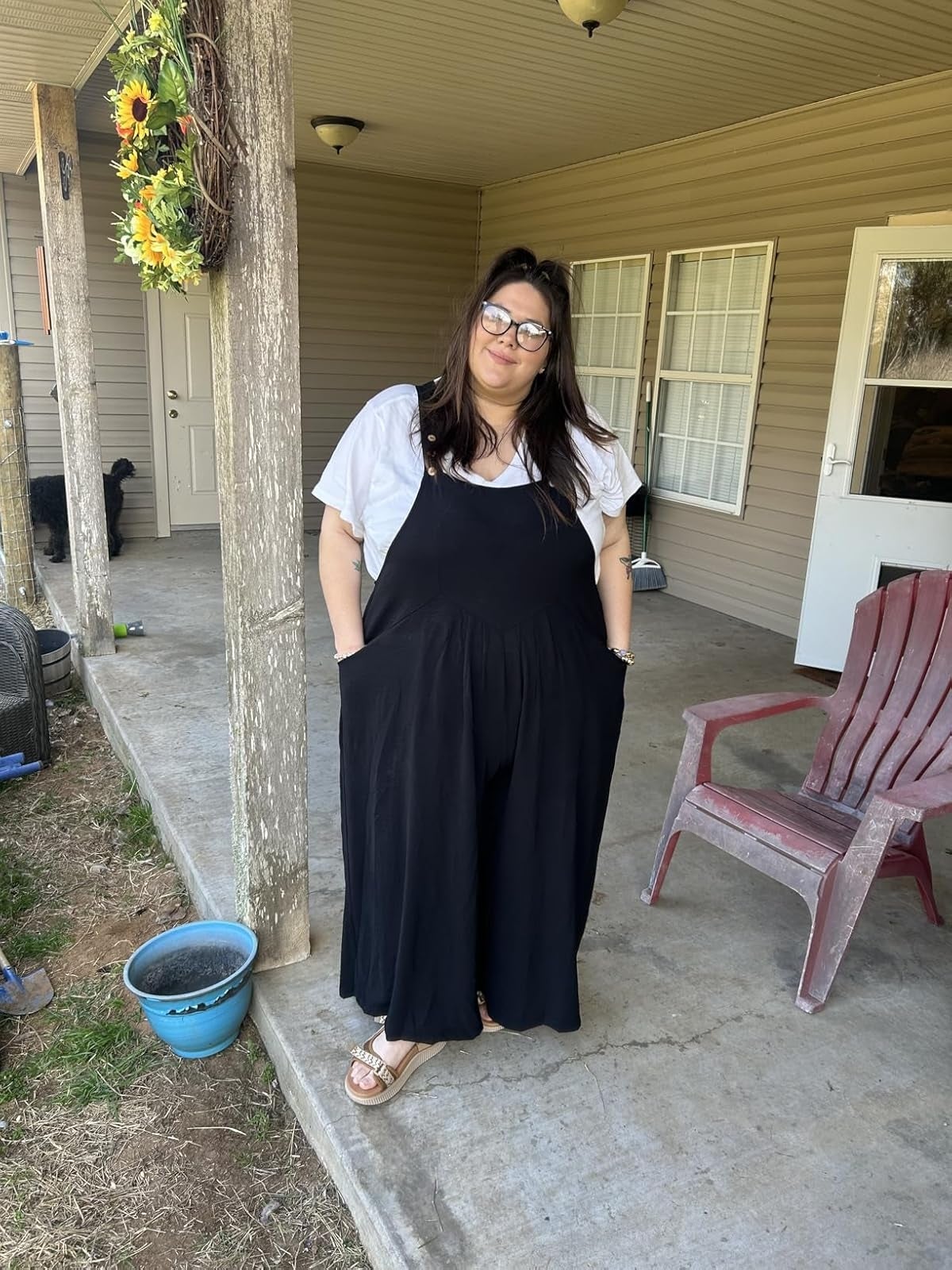 A idiosyncratic   stands connected  a structure  wearing a achromatic  garment  and achromatic  overalls