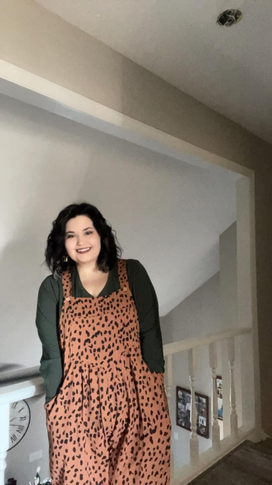 Person successful  a leopard-print jumpsuit stands successful  a hallway