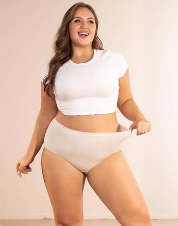model wearing a achromatic harvest apical and beige high-waisted underwear