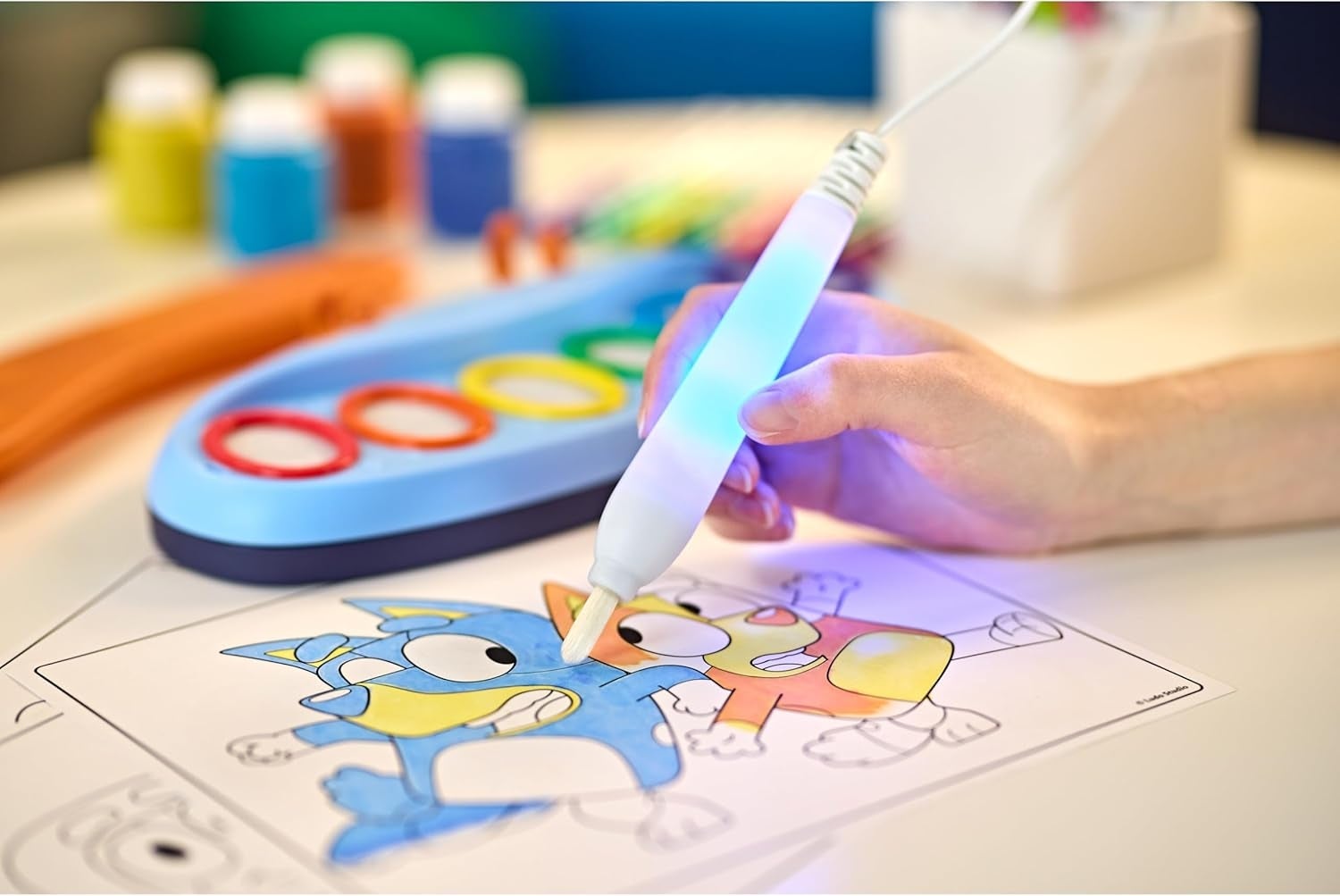 Child uses a integer  coloring instrumentality   connected  cartoon characters, surrounded by creation  supplies. Perfect for originative  young artists and tech-savvy families