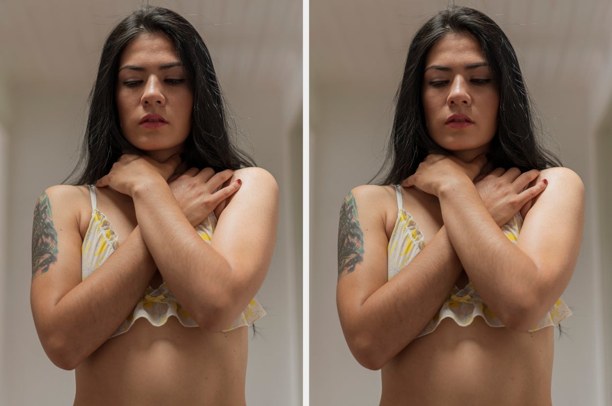 Person with long hair in a sleeveless top stands with hands clasped around neck, conveying a contemplative mood