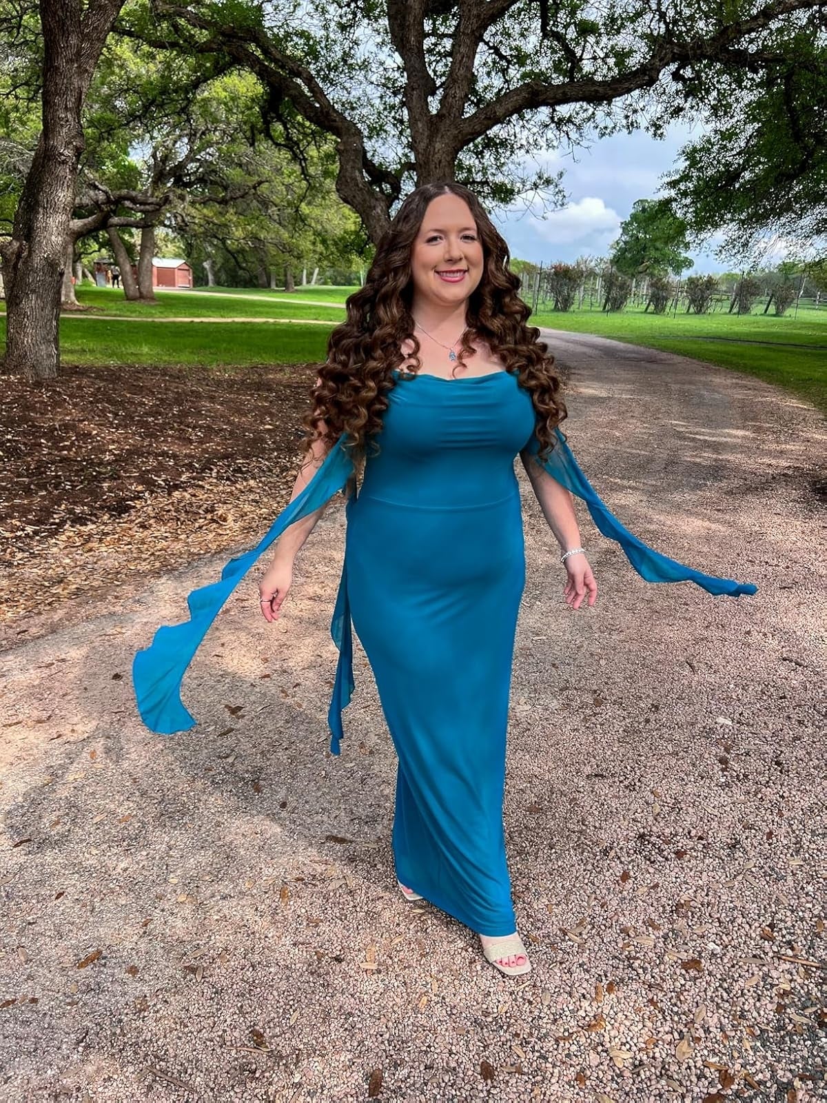 Person successful  a flowing gown with long, curly hairsbreadth  walks extracurricular  connected  a path